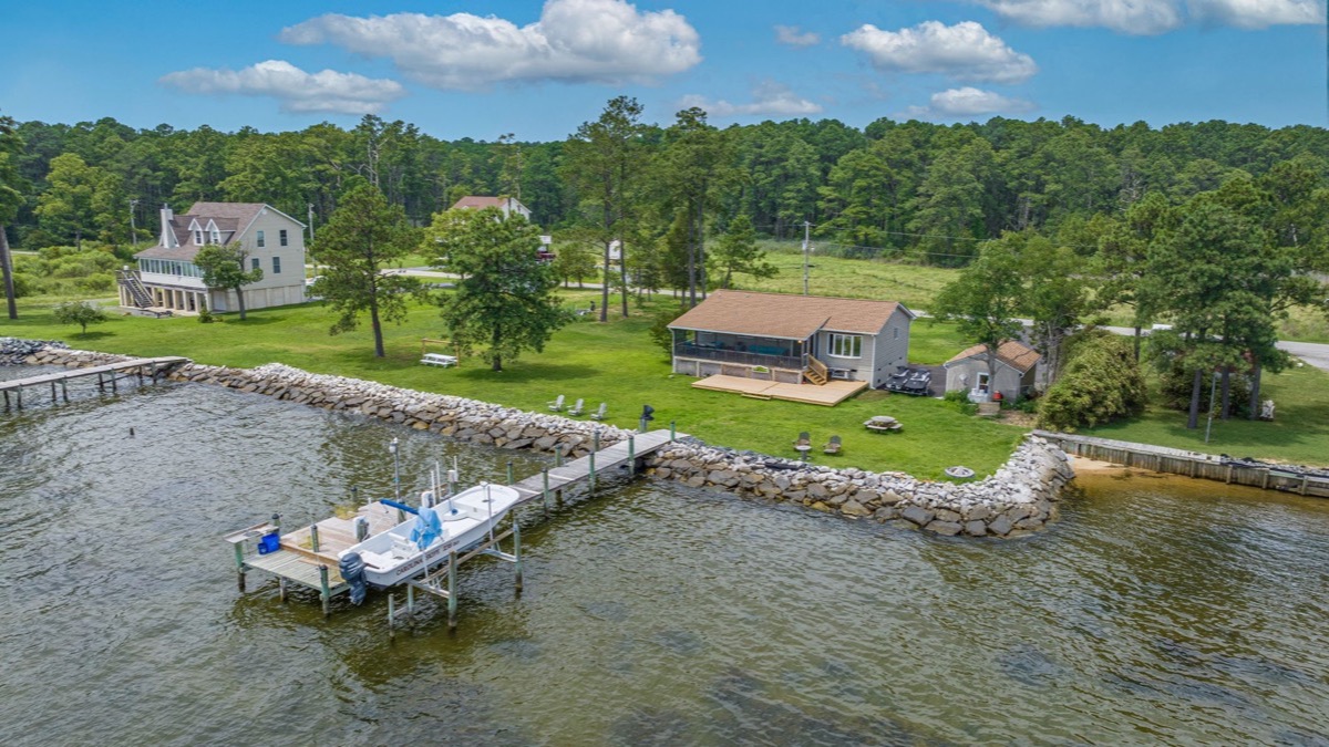 A Southern Maryland waterfront property at the shoreline with a pier reaching into the water